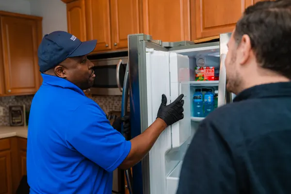 technician-fixing-a-kenmore-refrigerator-not-cooling