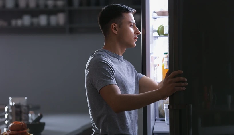A homeowner looks into his Samsung refrigerator trying to determine why it's not cooling.