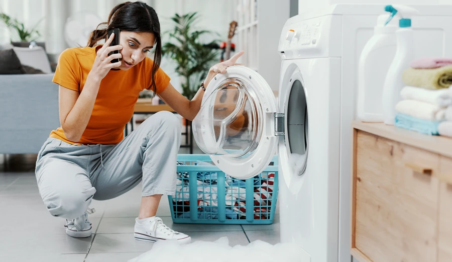 homeowner discovering a leaking washer