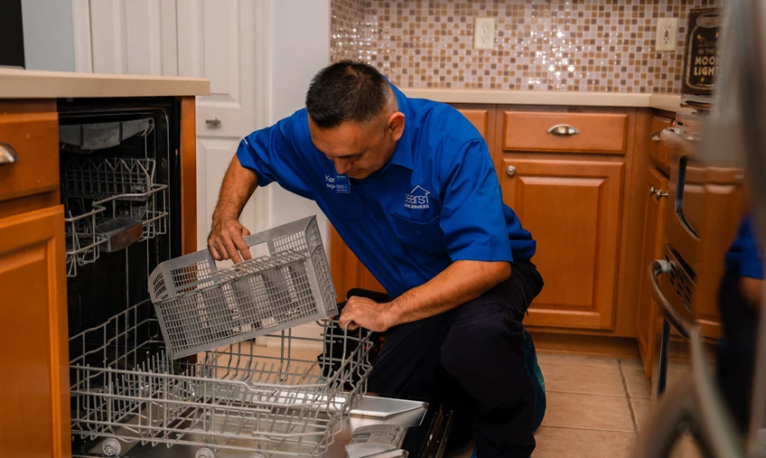 Sears technician repairing a dishwasher