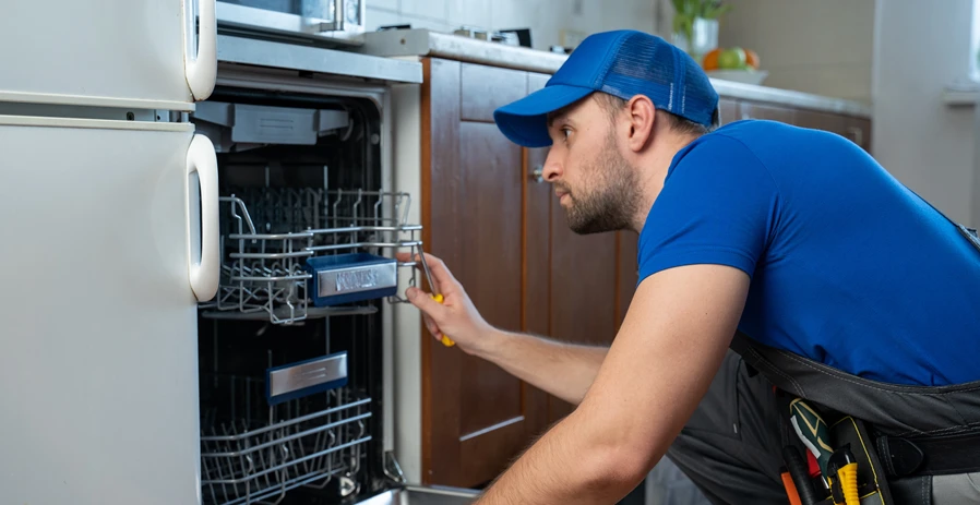 Image of a technician fixing a noisy dishwasher