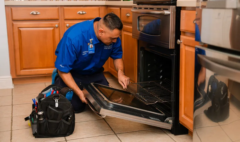 Sears tech fixing a gas oven that won't heat up