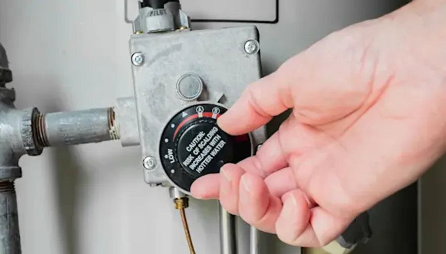 A homeowner trying to adjust hot water heater temperature because the hot water heater isn't working and need replacing