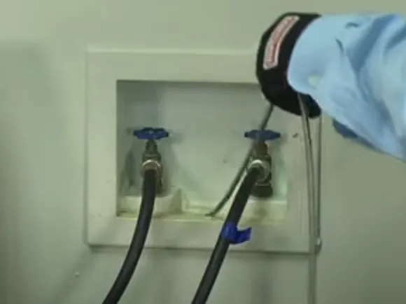 clear-the-washer-house-drain-using-a-plumbers-snake
