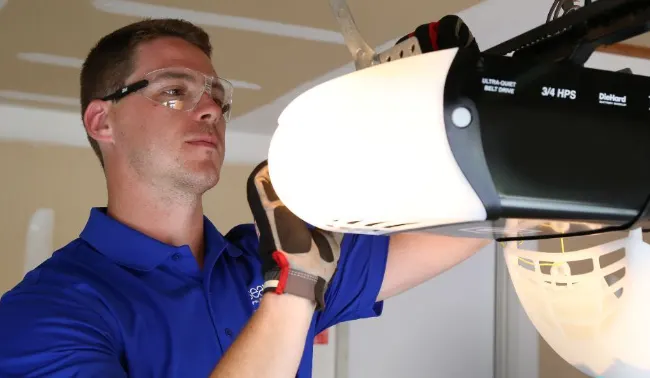 technician fixing a garage door opener that is flashing an error code