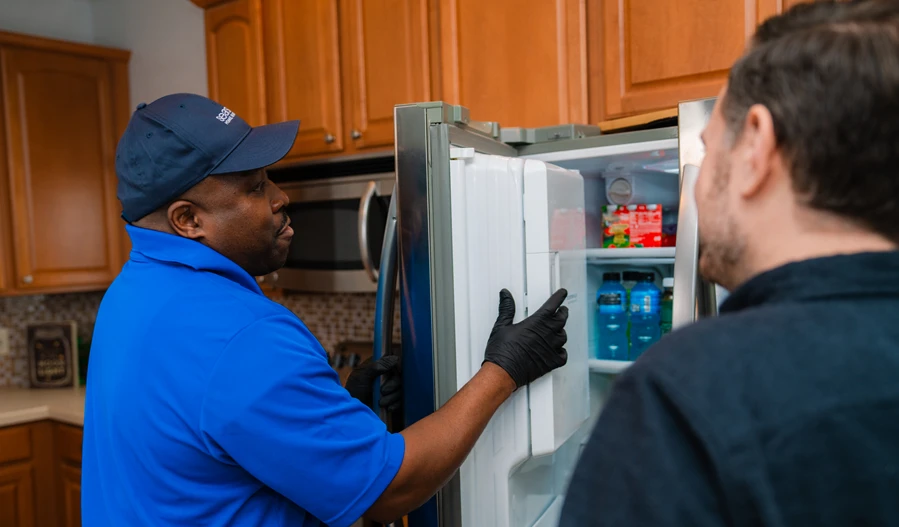 Sears Technician repairing a refrigerator not cooling