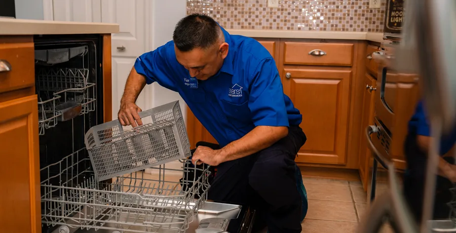 Sears tech examining a dishwasher and recognizing the telltale signs that you need a new dishwasher