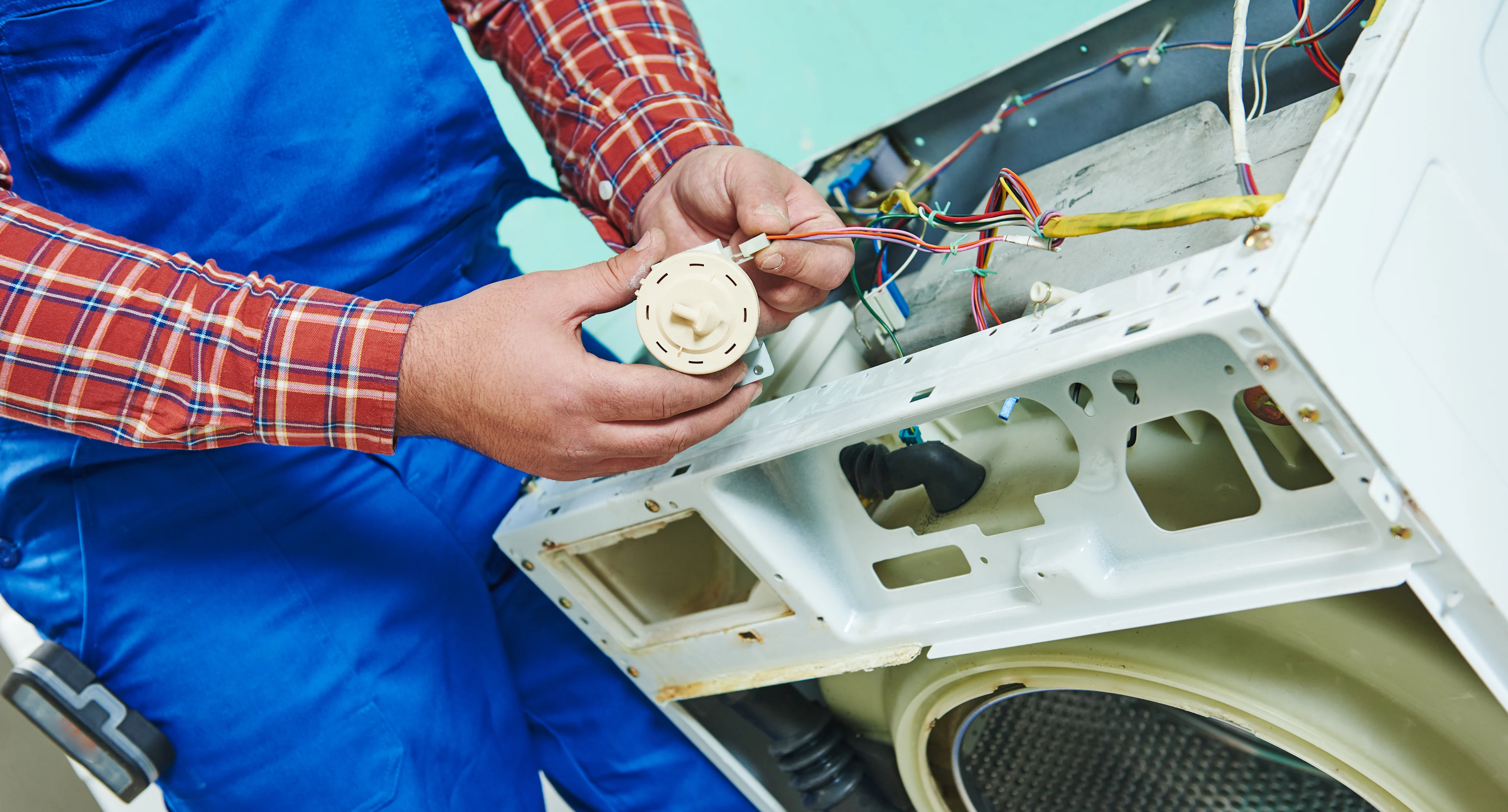 Sears Technician checking a water level pressure sensor