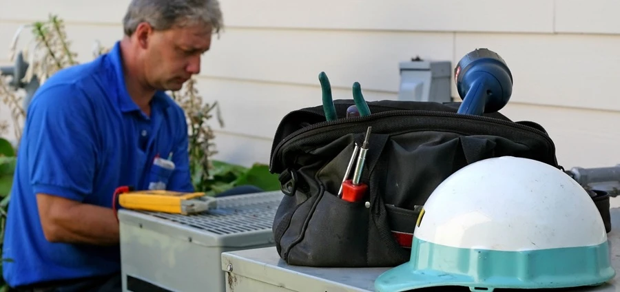 Sears Technician tuning up a central air conditioner