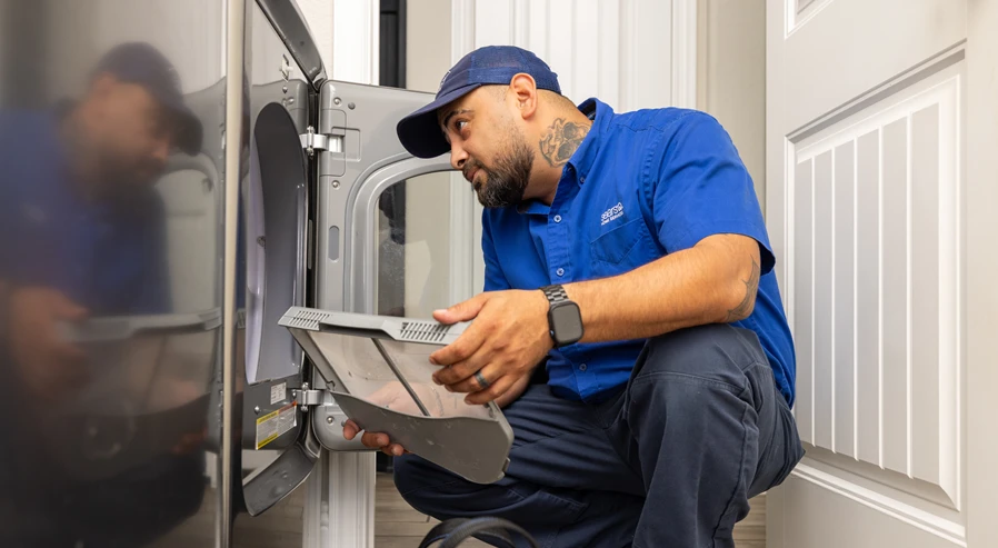 Sears Technician maintaining a dryer to extend its lifespan