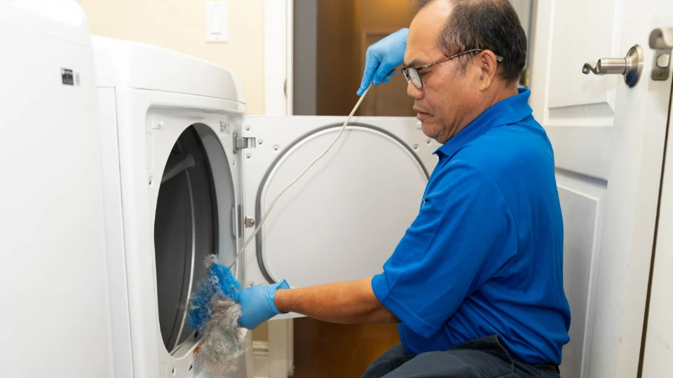 Technician repairing dryer
