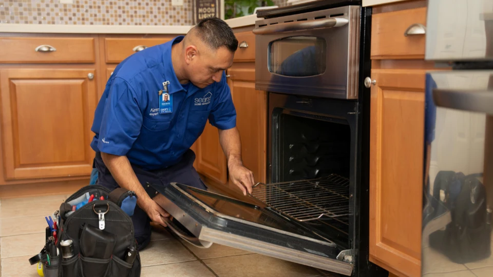 Technician repairing electric oven